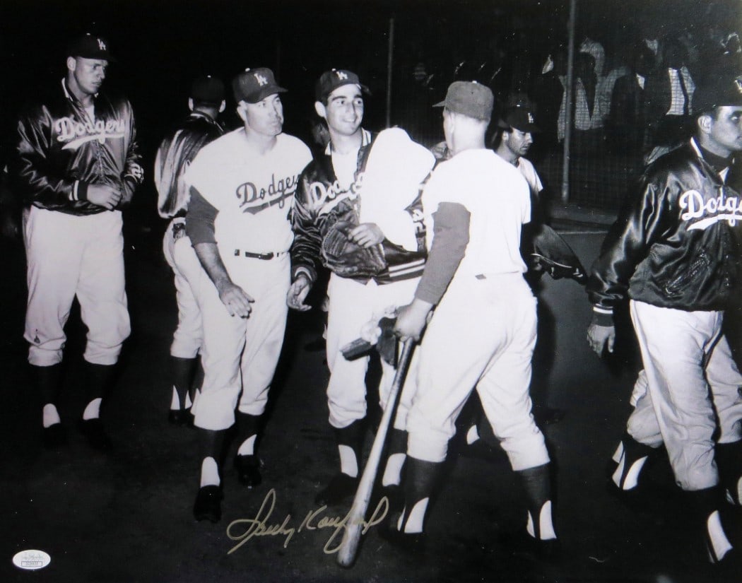Sandy Koufax Signed 16x20 Photo Dodgers Locker Room JSA Authenticated: Sandy Koufax Signed 16x20 Photo Dodgers Locker Room JSA Authenticated This is an original autographed 16X20 photo of Sandy Koufax, showcasing the legendary pitcher in the Dodgers' locker room alongsid