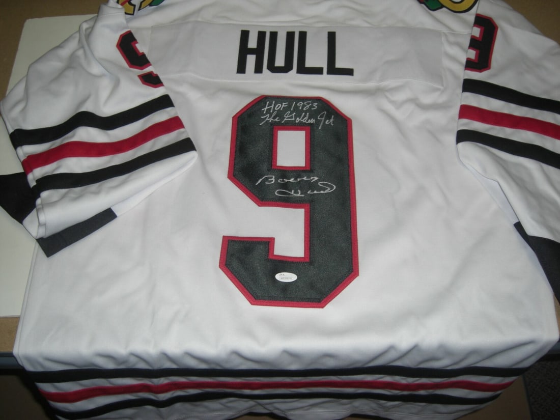 Signed Bobby Hull Chicago Blackhawks Jersey with JSA Hologram Authentication: Signed Bobby Hull Chicago Blackhawks Jersey with JSA Hologram Authentication This is a pre-owned Chicago Blackhawks jersey signed by Bobby Hull, known as the "Golden Jet" and a Hall of Fame inductee i
