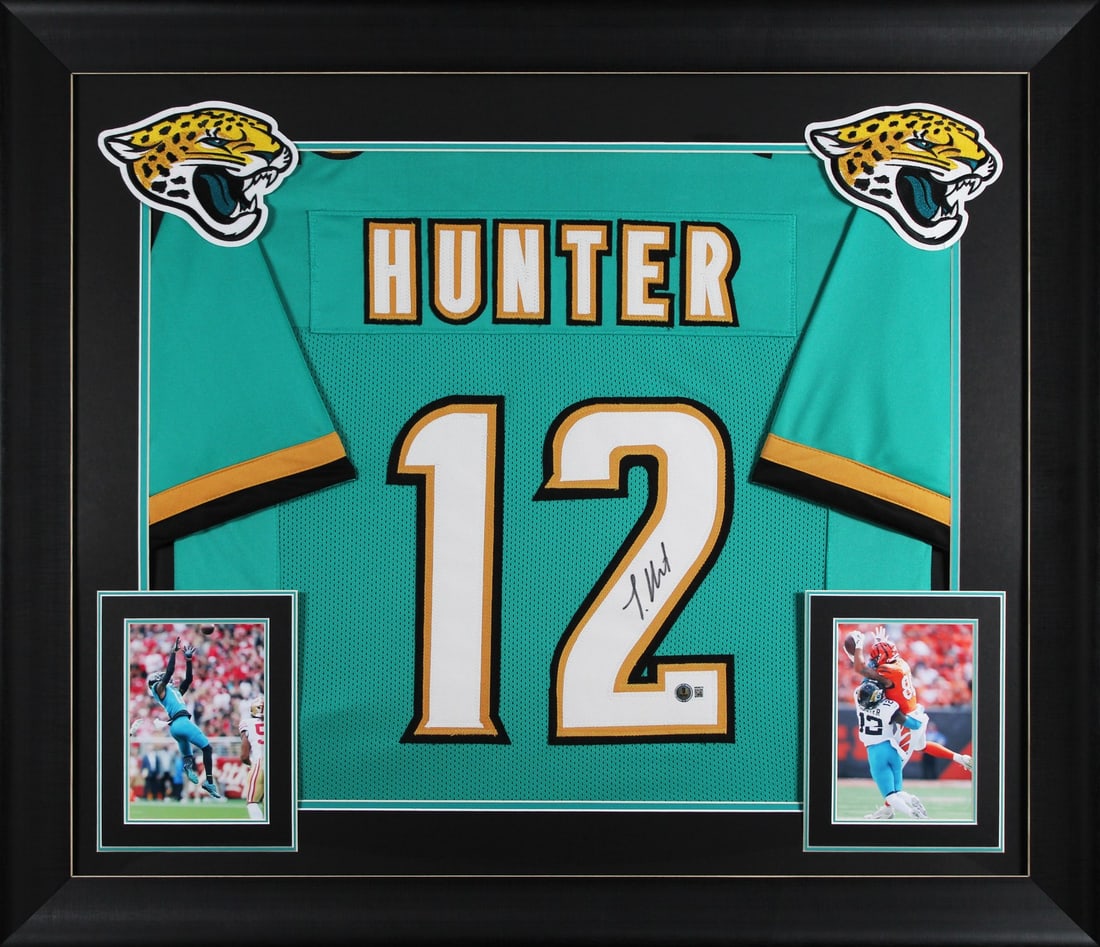 Framed Teal Pro Jersey Signed by Travis Hunter Beckett Authenticated: Framed Teal Pro Jersey Signed by Travis Hunter Beckett Authenticated This professionally framed teal alternate pro style jersey has been personally signed by Travis Hunter of the Jacksonville Jaguars.