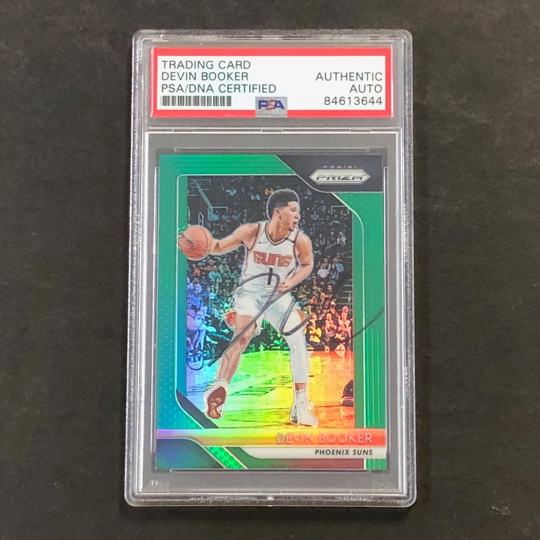 Devin Booker signed 2018-19 Panini Prizm Green PSA DNA card: Devin Booker signed 2018-19 Panini Prizm Green PSA DNA card This is a 2018-19 Panini Prizm Green #11 trading card featuring Devin Booker of the Phoenix Suns. The card has been personally signed by Dev