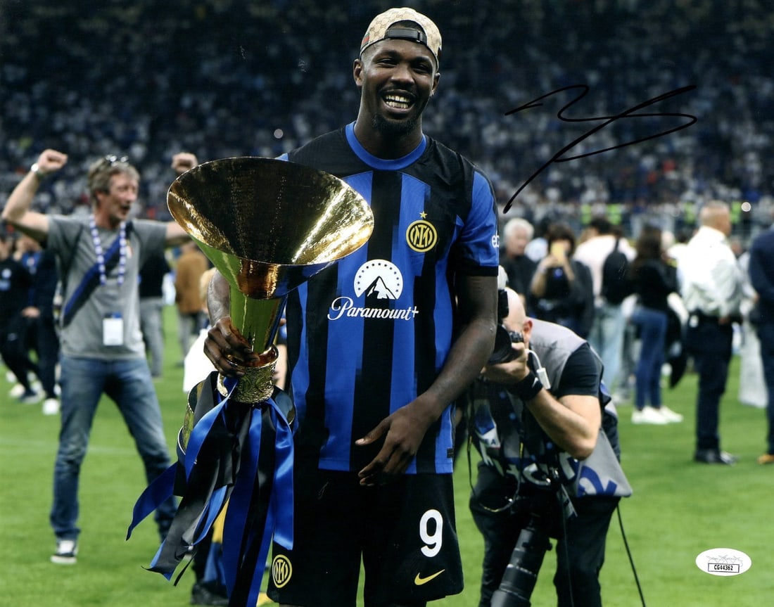 Marcus Thuram Autographed 11X14 Inter Milan Photo JSA Certified: Marcus Thuram Autographed 11X14 Inter Milan Photo JSA Certified This is an original 11X14 photo of Marcus Thuram, featuring the Inter Milan team and their trophy. The photo is autographed by Thuram an