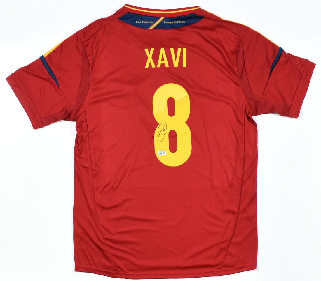 Spain National Team Jersey Signed by Xavi with Beckett Authentication: Spain National Team Jersey Signed by Xavi with Beckett Authentication This is a pre-owned Spain home soccer jersey, autographed by Xavi and featuring his number 8. The jersey is authenticated by a Bec