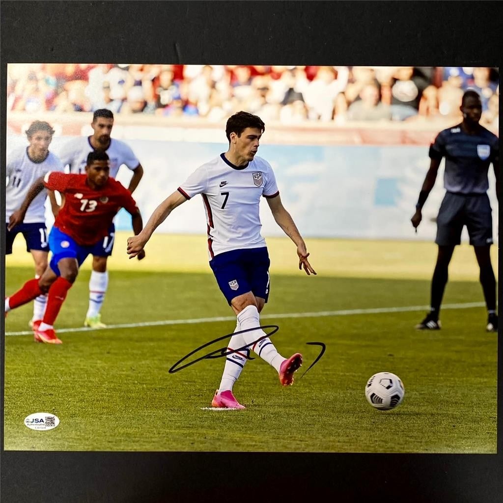 Autographed 11x14 Soccer Photo Giovanni Reyna USA JSA Authenticated: Autographed 11x14 Soccer Photo Giovanni Reyna USA JSA Authenticated This 11x14 photograph features a genuine autograph from Giovanni Reyna, representing Team USA (USMNT) soccer. The signature is authe