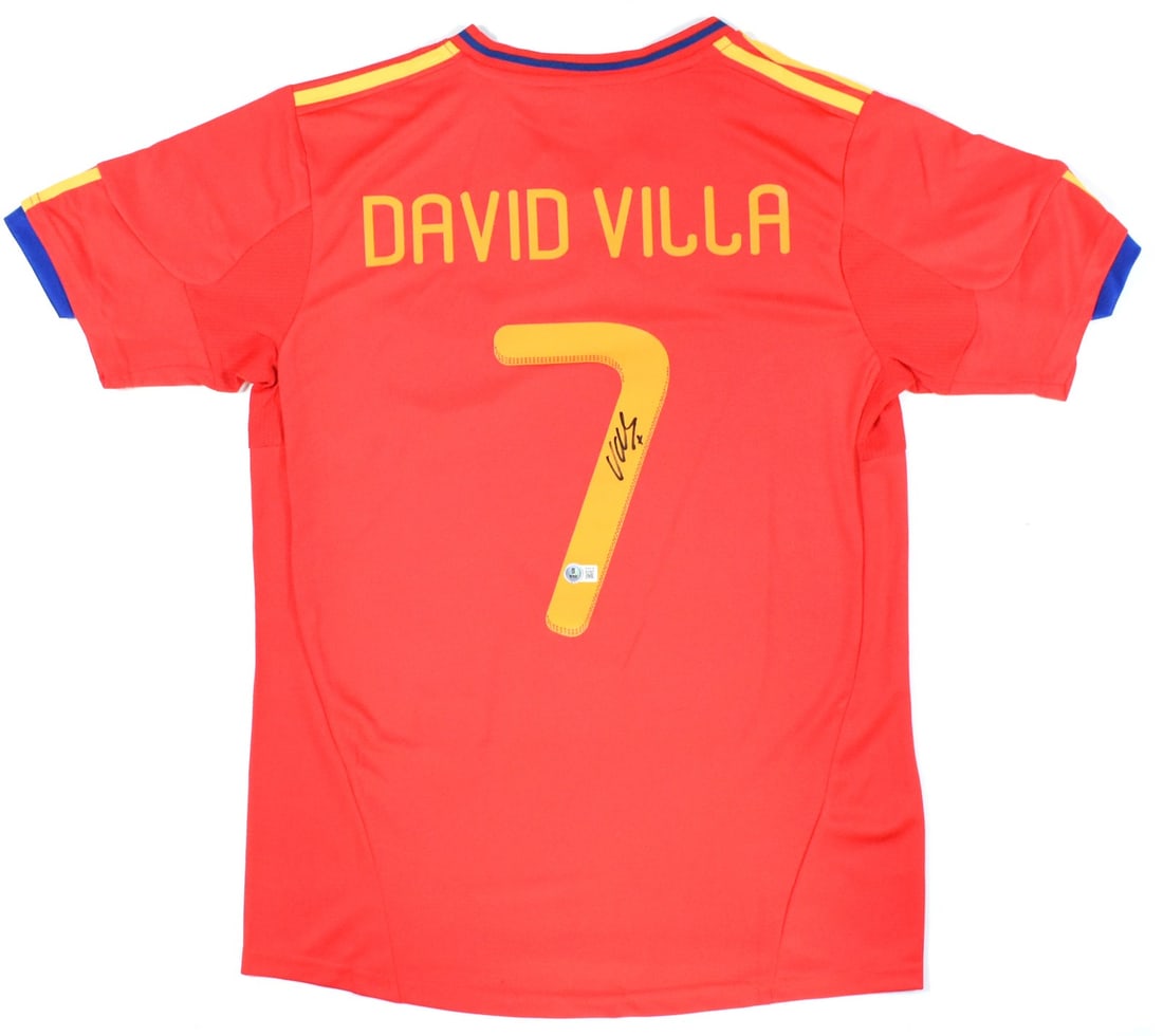 Spain Home Jersey Signed by David Villa with Beckett Hologram: Spain Home Jersey Signed by David Villa with Beckett Hologram This Spain home soccer jersey features the number 7 and has been autographed by David Villa. The jersey is an original item and is in pre-