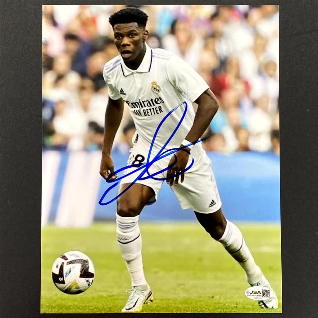 Autographed 8.5x11 Photo Real Madrid Aurelien Tchouameni Beckett Authenticated: Autographed 8.5x11 Photo Real Madrid Aurelien Tchouameni Beckett Authenticated This is an original 8.5x11 photo signed by Aurelien Tchouameni, the Real Madrid and France soccer player. The autograph i
