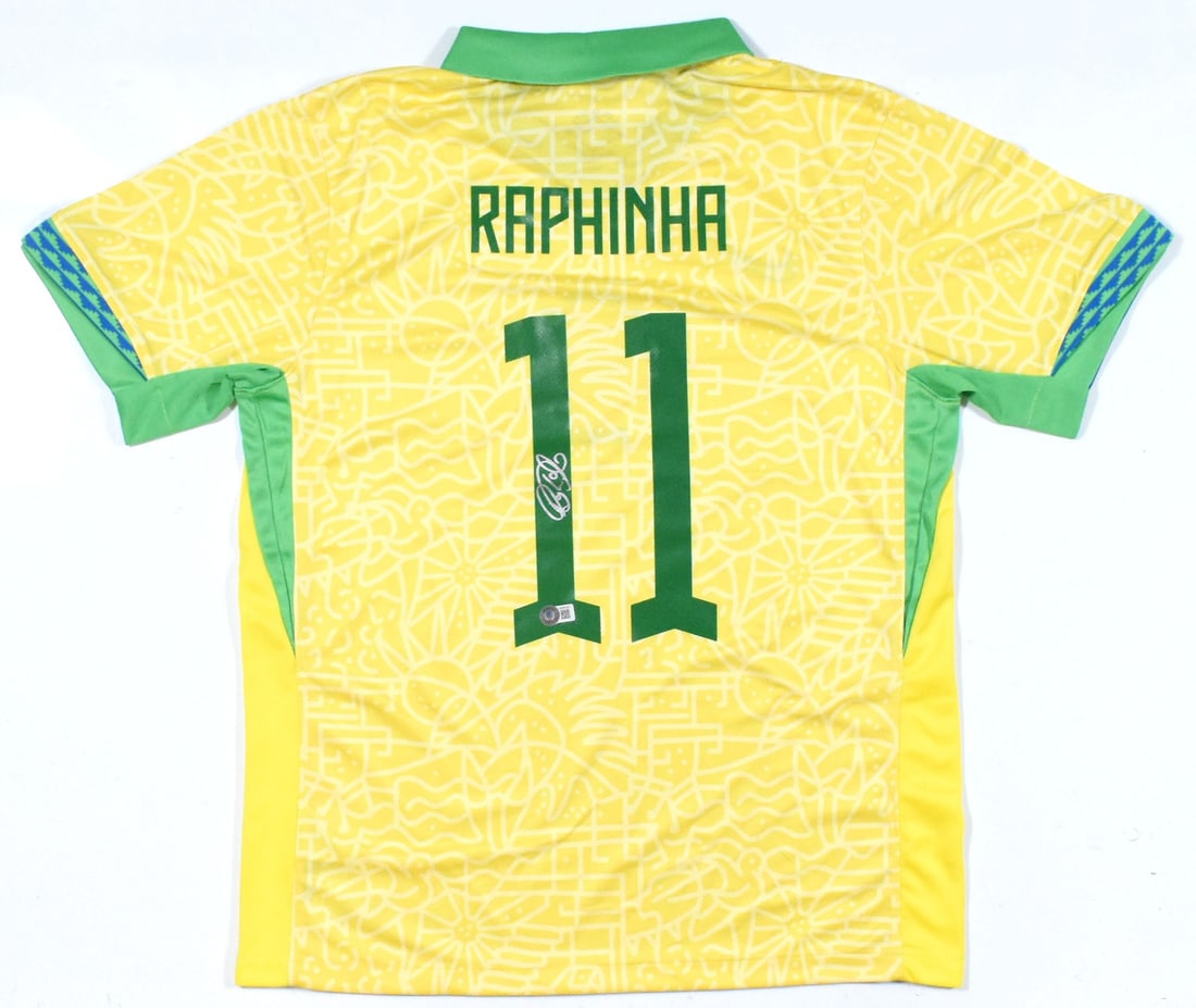 Brazil Home Soccer Jersey Signed by Raphinha Number 11 Beckett Hologram: Brazil Home Soccer Jersey Signed by Raphinha Number 11 Beckett Hologram This is a pre-owned Brazil home soccer jersey featuring the number 11 and autographed by Raphinha. The jersey comes with a Becke