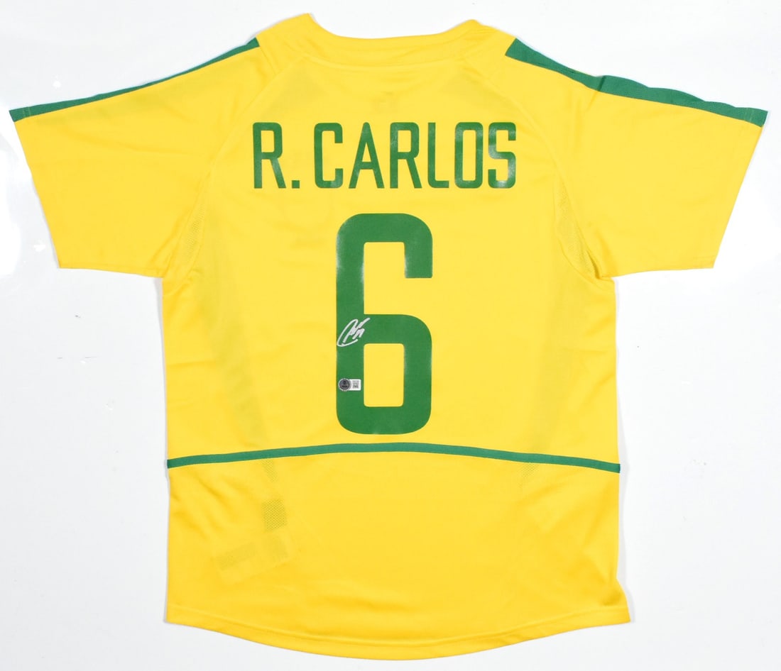 Brazil Home Jersey Signed by Roberto Carlos Beckett Holo #6: Brazil Home Jersey Signed by Roberto Carlos Beckett Holo #6 This Brazil home soccer jersey features the autograph of renowned player Roberto Carlos and displays his number 6. The jersey is an original