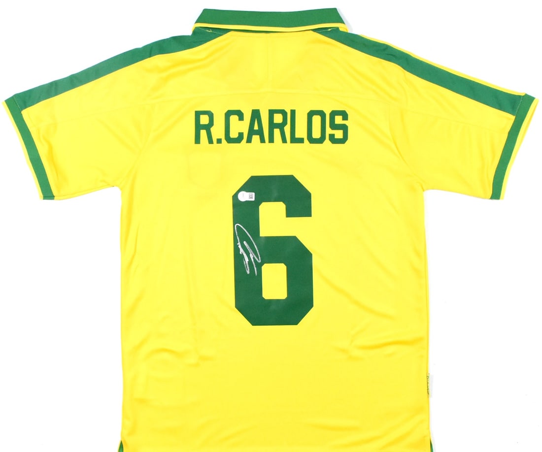 Autographed Brazil Home Jersey Number 6 Roberto Carlos Beckett Authenticated: Autographed Brazil Home Jersey Number 6 Roberto Carlos Beckett Authenticated This is a Brazil home yellow soccer jersey featuring the number 6 and signed by Roberto Carlos. The jersey is an original i