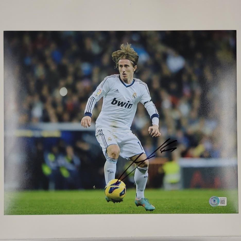 Luka Modric Real Madrid 11x14 Signed Soccer Photo Beckett Authenticated: Luka Modric Real Madrid 11x14 Signed Soccer Photo Beckett Authenticated This is an original 11x14 photo of Luka Modric, signed by the player. The autograph is authenticated by Beckett Authentication S