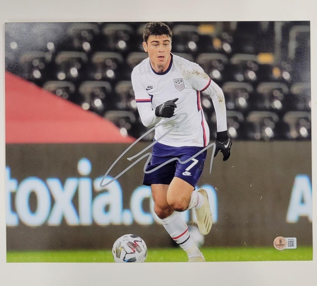 Giovanni Reyna Signed USMNT 11x14 Photo Beckett Authenticated: Giovanni Reyna Signed USMNT 11x14 Photo Beckett Authenticated Capture a piece of soccer history with this Giovanni Gio Reyna signed 11x14 photo. The photograph features the talented player representin