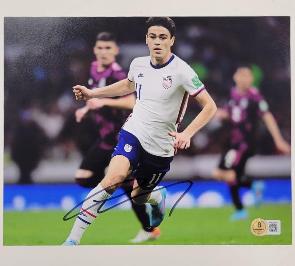 Giovanni Gio Reyna Signed USMNT 8x10 Photo Beckett Authenticated: Giovanni Gio Reyna Signed USMNT 8x10 Photo Beckett Authenticated This is an authentic 8x10 photo of Giovanni Gio Reyna, a member of the US Men's National Team (USMNT), featuring his signature. The aut