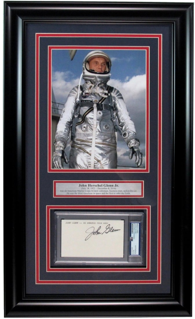 Framed John Glenn signed 3x5 index card display PSA DNA: Framed John Glenn signed 3x5 index card display PSA DNA This framed display features a 3x5 index card hand-signed by astronaut John Glenn, accompanied by a photo collage commemorating his historic ach