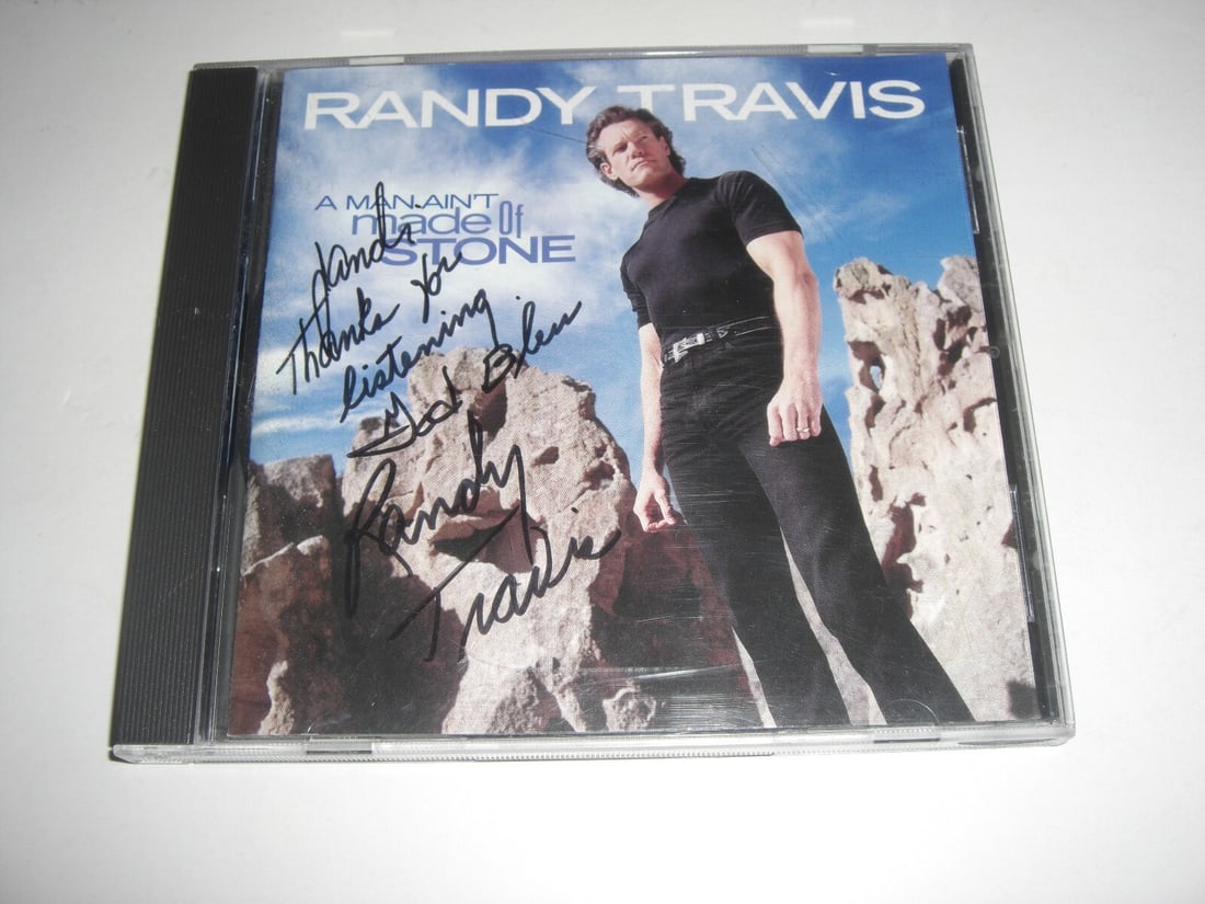 Signed Randy Travis CD A Man Aint Made of Stone with COA: Signed Randy Travis CD A Man Aint Made of Stone with COA This is an original signed CD of Randy Travis's album "A Man Ain't Made of Stone." The item includes a certificate of authenticity (COA) and fe