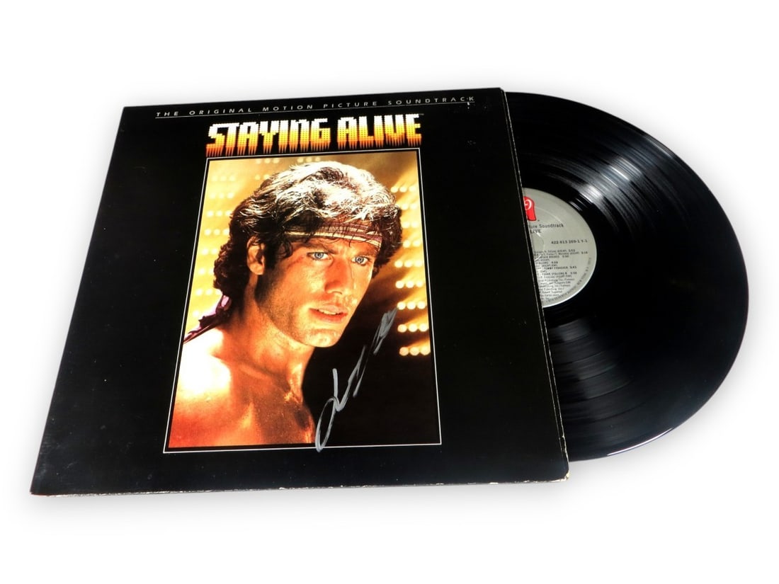 John Travolta Signed Staying Alive Album Cover JSA Authenticated: John Travolta Signed Staying Alive Album Cover JSA Authenticated Celebrate the iconic career of John Travolta with this autographed record album cover from the classic film 'Staying Alive.' The album 