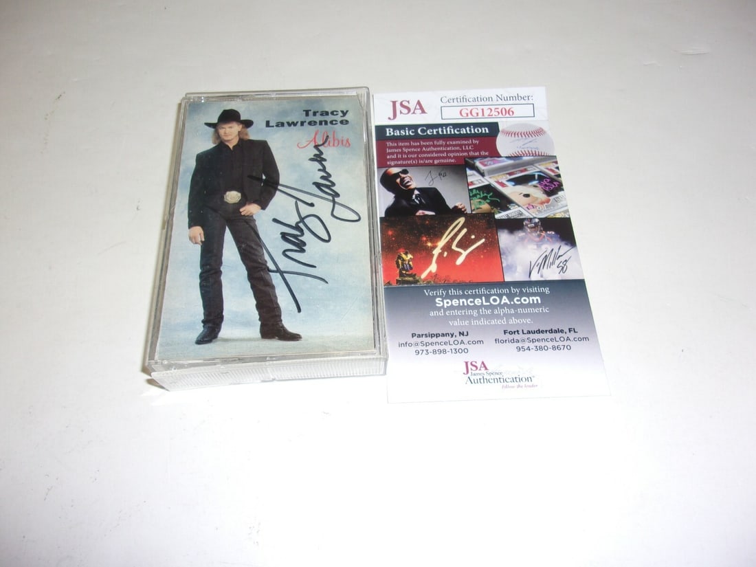 Alibis Cassette Album Signed by Tracy Lawrence with JSA Authentication: Alibis Cassette Album Signed by Tracy Lawrence with JSA Authentication This is a pre-owned original cassette tape album of "Alibis" by Tracy Lawrence, featuring both the tape and booklet from the Unit