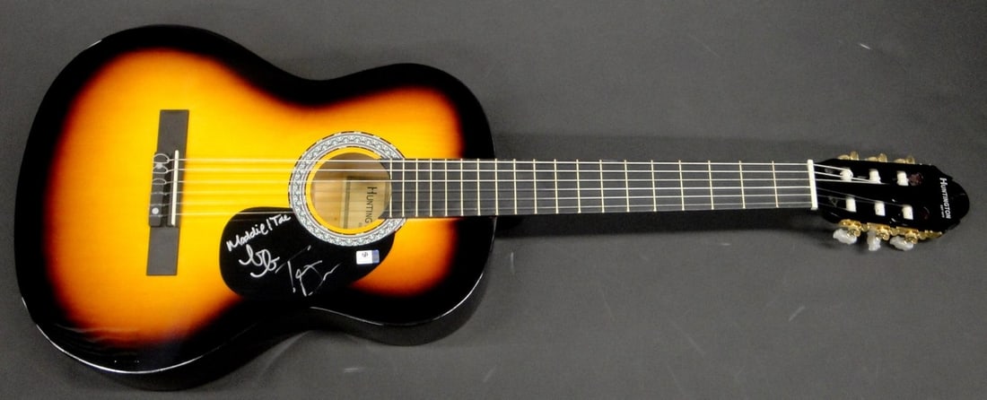 Autographed Guitar by Maddie Marlow and Taylor Dye with Global Authentics COA: Autographed Guitar by Maddie Marlow and Taylor Dye with Global Authentics COA This is an acoustic guitar autographed by Maddie Marlow and Tae Dye of the country music duo Maddie & Tae. The guitar is a