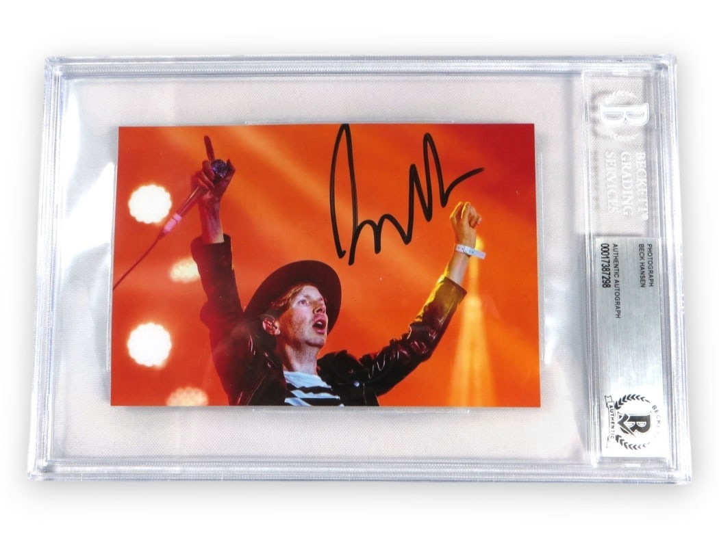 Beck Hansen Autographed 4X6 Photo On Stage Beckett Authenticated: Beck Hansen Autographed 4X6 Photo On Stage Beckett Authenticated This is an original 4X6 photograph of Beck Hansen performing on stage, personally signed by the artist. The autograph has been authenti