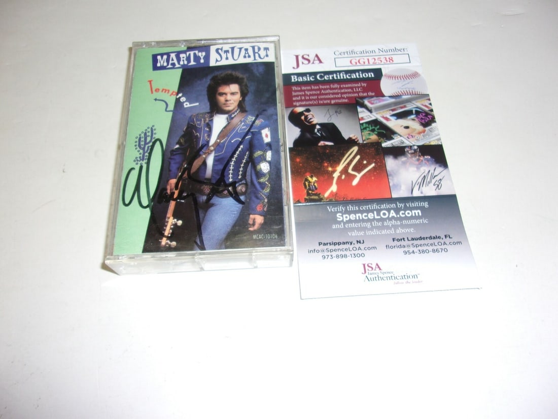 Signed Marty Stuart Tempted Cassette Album with JSA COA and Booklet: Signed Marty Stuart Tempted Cassette Album with JSA COA and Booklet This pre-owned cassette tape album features country singer Marty Stuart and is an original release from the United States. The casse
