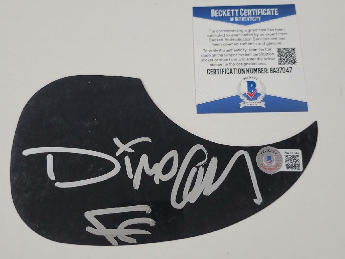 Fear Factory Dino Cazares Autographed Black Pickguard Beckett Authenticated: Fear Factory Dino Cazares Autographed Black Pickguard Beckett Authenticated This original black guitar pickguard has been hand-signed in silver by Dino Cazares of Fear Factory. The autograph is