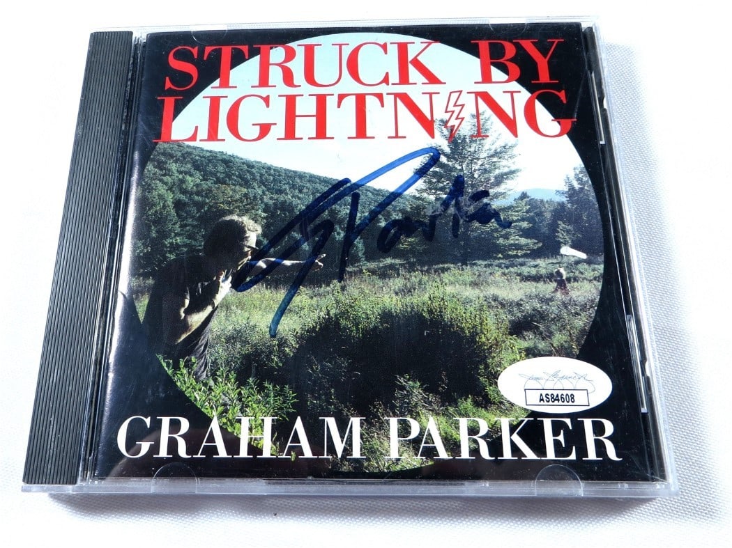 Graham Parker Autographed CD Booklet Struck By Lightning JSA Certified: Graham Parker Autographed CD Booklet Struck By Lightning JSA Certified This is an original autographed CD booklet by Graham Parker, featuring the album "Struck By Lightning." The set includes the CD, 