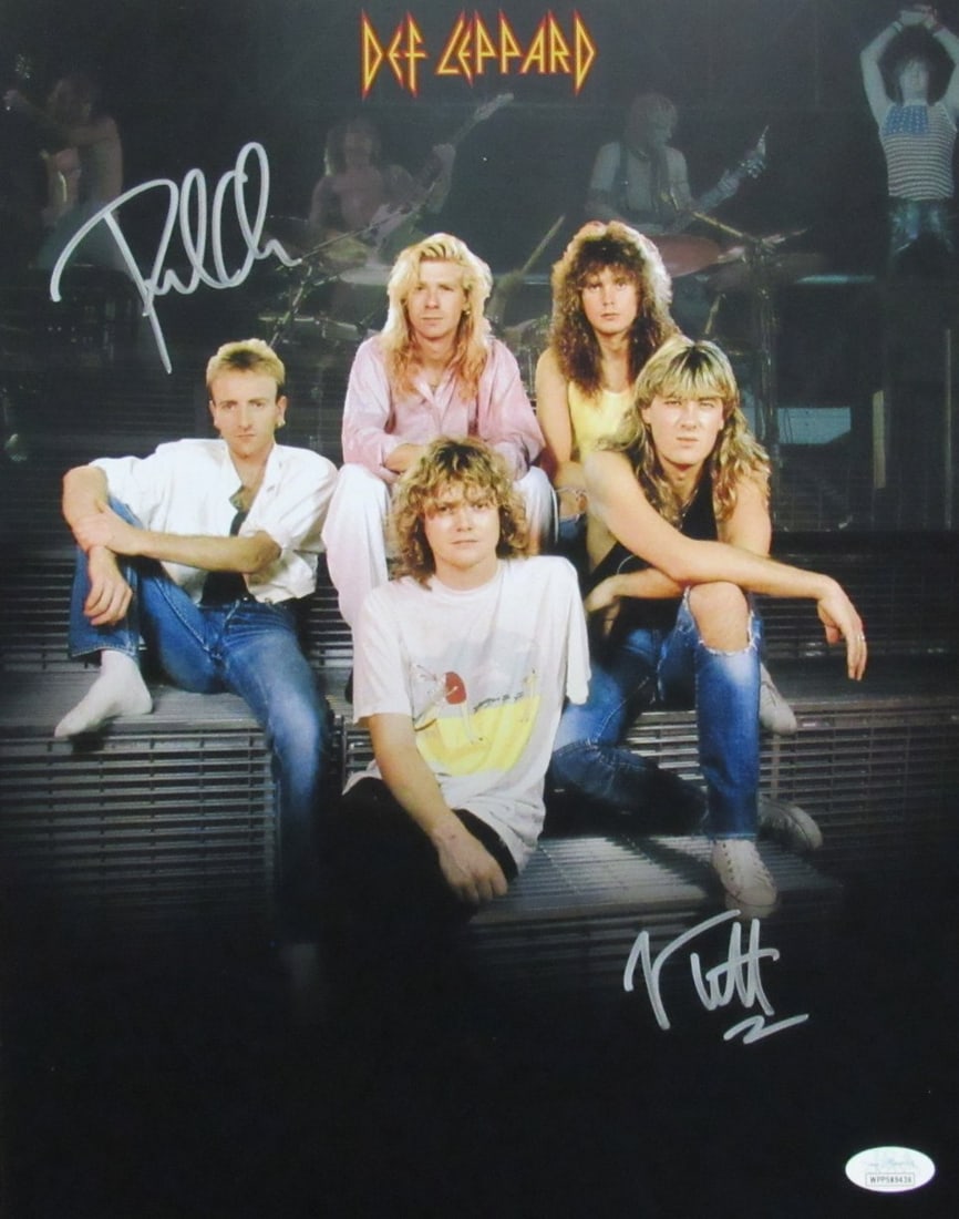 Def Leppard 11x14 Photo Signed by Joe Elliott and Phil Collen JSA Authenticated: Def Leppard 11x14 Photo Signed by Joe Elliott and Phil Collen JSA Authenticated This is an original 11x14 photo autographed by Joe Elliott and Phil Collen of Def Leppard. The photo originates from the