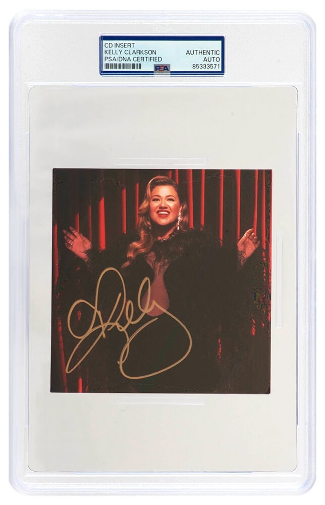 Kelly Clarkson Autographed When Christmas Comes Around 5x5 CD Insert PSA/DNA: Kelly Clarkson Autographed When Christmas Comes Around 5x5 CD Insert PSA/DNA This is a Kelly Clarkson signed 'When Christmas Comes Around' 5x5 CD insert, beautifully encapsulated for preservation. The