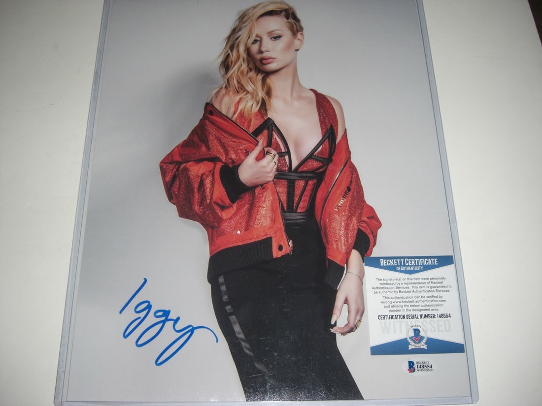 Iggy Azalea Signed 11x14 Photo in Black Jumpsuit Beckett COA: Iggy Azalea Signed 11x14 Photo in Black Jumpsuit Beckett COA This is an original 11x14 photograph featuring musician and rapper Iggy Azalea in a black jumpsuit. The photo has been hand-signed and come