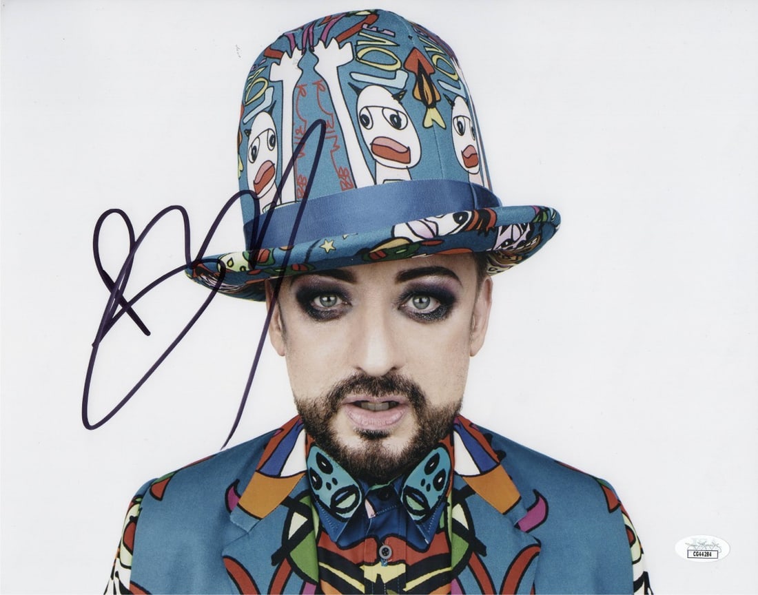 Boy George Autographed 11X14 Culture Club Photo JSA Certified: Boy George Autographed 11X14 Culture Club Photo JSA Certified This is an original 11X14 photograph of Boy George, featuring him in a cartoon suit, autographed by the artist himself. The signature has 