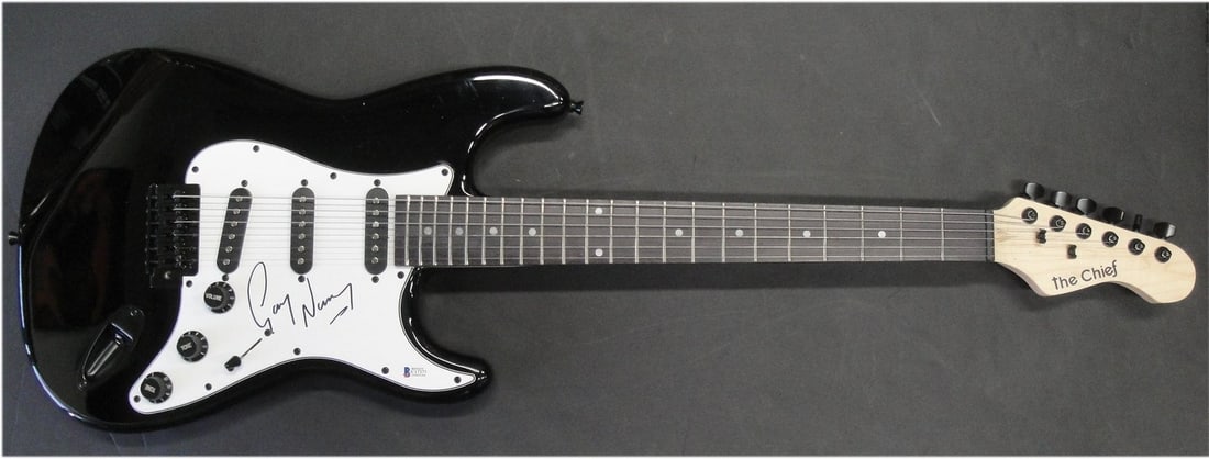 Electric Guitar Signed by Gary Numan Beckett Authenticated: Electric Guitar Signed by Gary Numan Beckett Authenticated This electric guitar and accompanying guitar pick have been hand-signed by Gary Numan. The autograph has been authenticated by Beckett Autogr