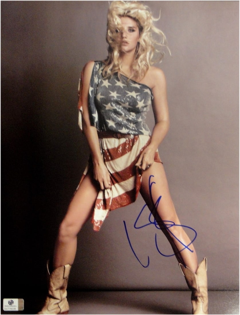 Kesha Ke$ha Autographed 11X14 Photo Sexy America Outfit GAI Authenticated: Kesha Ke$ha Autographed 11X14 Photo Sexy America Outfit GAI Authenticated This is an original autographed 11" x 14" photograph of Kesha, featuring her in a striking America-themed outfit. The signatur