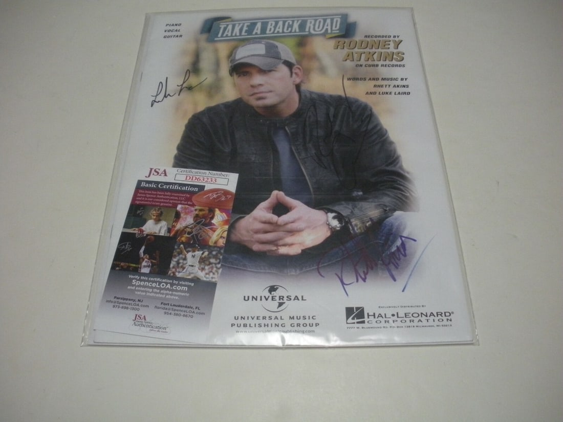 Rodney Atkins Signed Take a Back Road Sheet Music JSA COA Authenticated: Rodney Atkins Signed Take a Back Road Sheet Music JSA COA Authenticated This is an original sheet music for "Take a Back Road" by Rodney Atkins, signed by one individual. The sheet music comes with a 