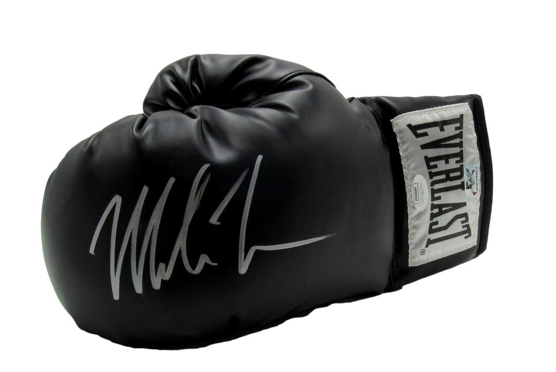 Mike Tyson Signed Black Everlast Boxing Glove Left JSA 149808: Mike Tyson Signed Black Everlast Boxing Glove Left JSA 149808 Own a piece of boxing history with this authentic, signed black Everlast boxing glove by legendary champion Mike Tyson. This left-hand glo
