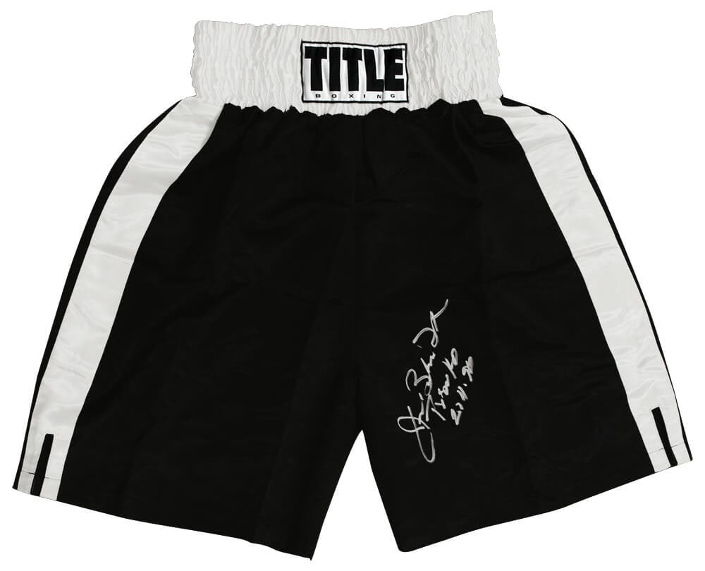 James Buster Douglas Signed Boxing Trunks with Tyson KO Inscription: James Buster Douglas Signed Boxing Trunks with Tyson KO Inscription Own a piece of boxing history with these James Buster Douglas signed Title black boxing trunks featuring white trim. Inscribed with 