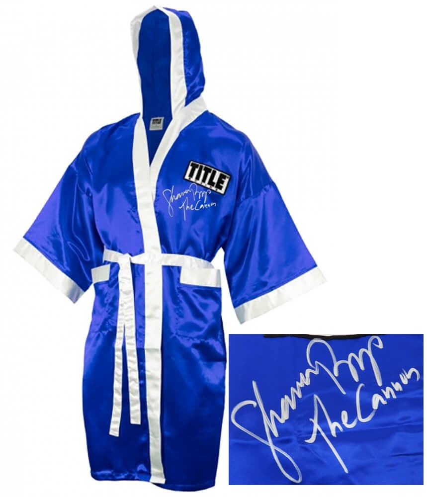 Shannon Briggs Signed Blue Boxing Robe with 'The Cannon' Inscription: Shannon Briggs Signed Blue Boxing Robe with 'The Cannon' Inscription This original Shannon Briggs signed Title boxing robe features a striking blue design with white trim and is inscribed with 'The Ca