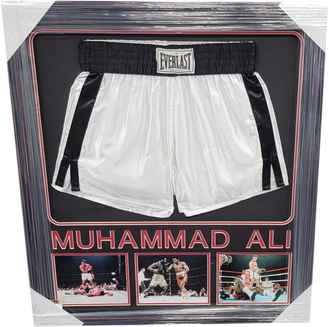 Muhammad Ali Hand Signed Framed Boxing Trunks GAI Authenticated: Muhammad Ali Hand Signed Framed Boxing Trunks GAI Authenticated This exceptional item features authentic boxing trunks hand-signed by the legendary Muhammad Ali, beautifully custom framed for display.