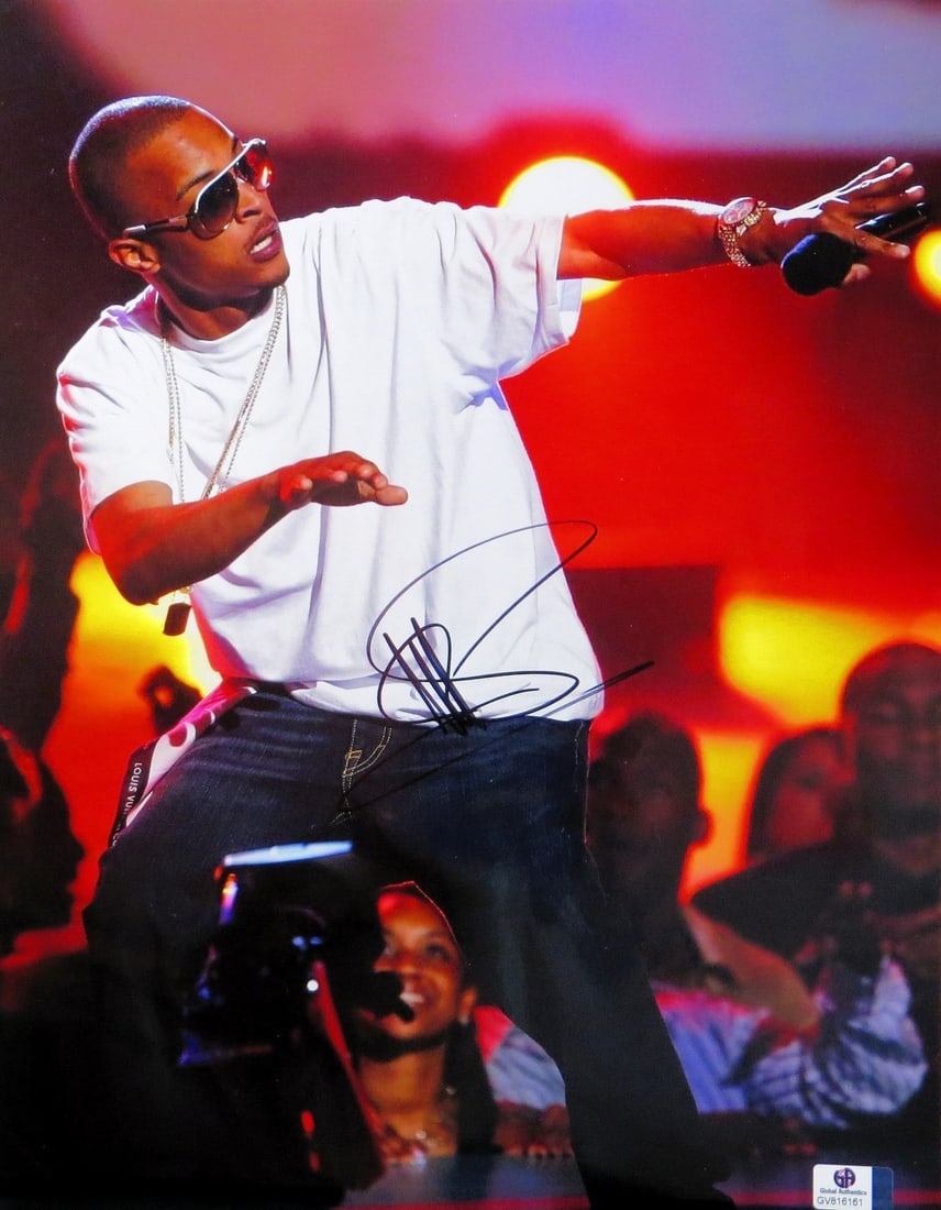 TI Clifford Harris Signed 11X14 Photo Authenticated by Global Authentics: TI Clifford Harris Signed 11X14 Photo Authenticated by Global Authentics This is an authentic 11" x 14" photo of TI, also known as Clifford Harris, captured on stage wearing a white shirt. The photogr