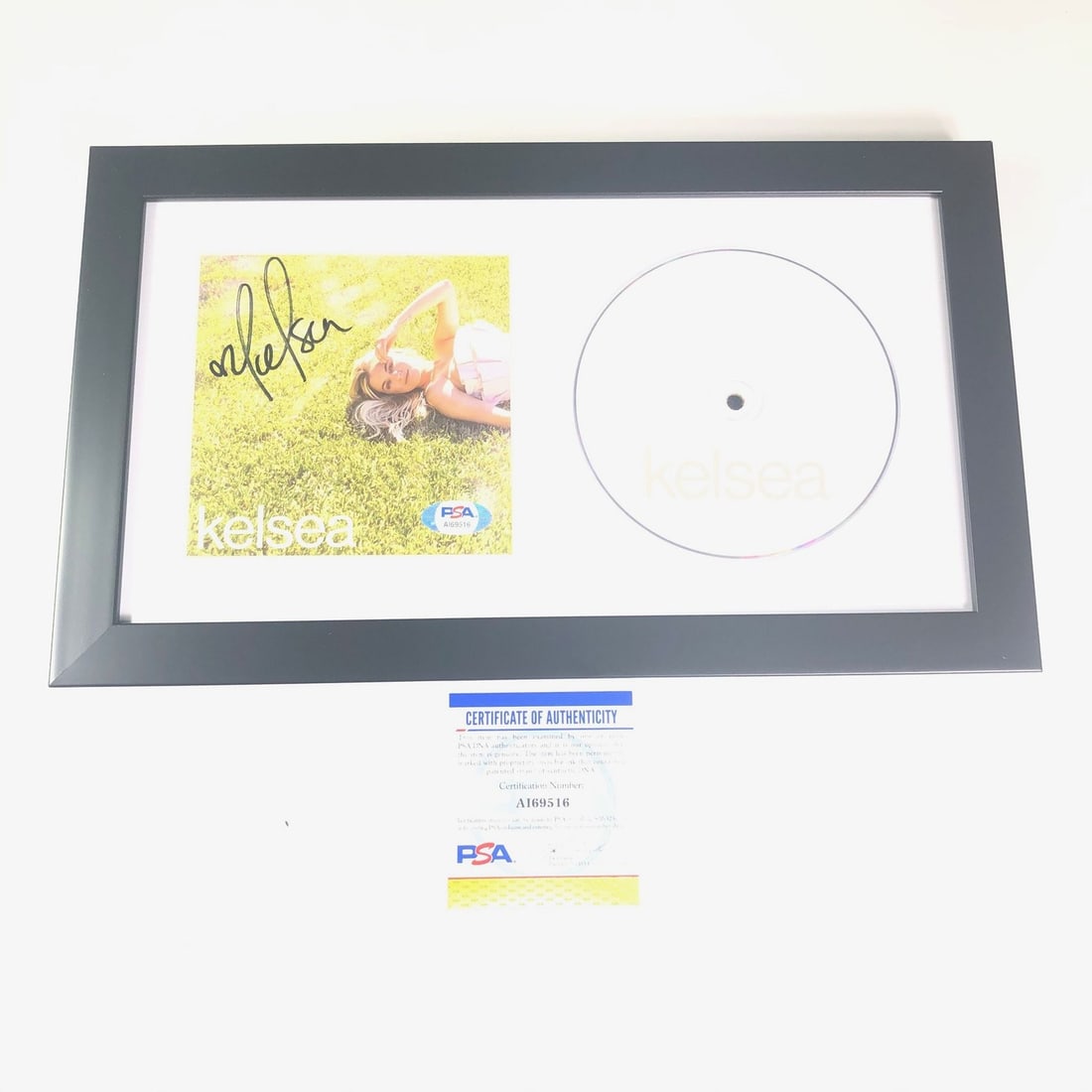 Framed CD Album Cover Signed by Kelsea Ballerini with PSA/DNA Authentication: Framed CD Album Cover Signed by Kelsea Ballerini with PSA/DNA Authentication This is a framed CD album cover featuring the autograph of Kelsea Ballerini. The signature has been authenticated by PSA/DN