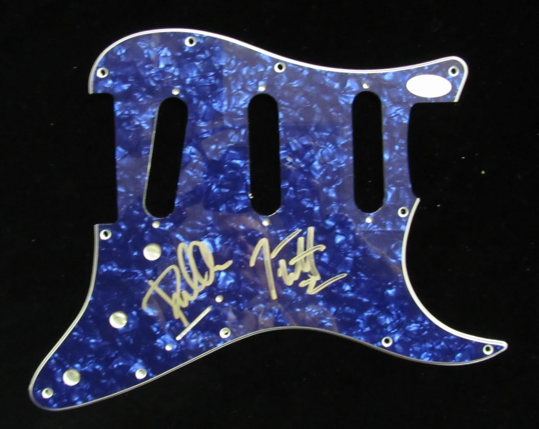 Guitar Pick Guard Hand Signed by Joe Elliott and Phil Collen JSA Authenticated: Guitar Pick Guard Hand Signed by Joe Elliott and Phil Collen JSA Authenticated This is a guitar pick guard hand-signed by Joe Elliott and Phil Collen of Def Leppard. The item is authenticated by James