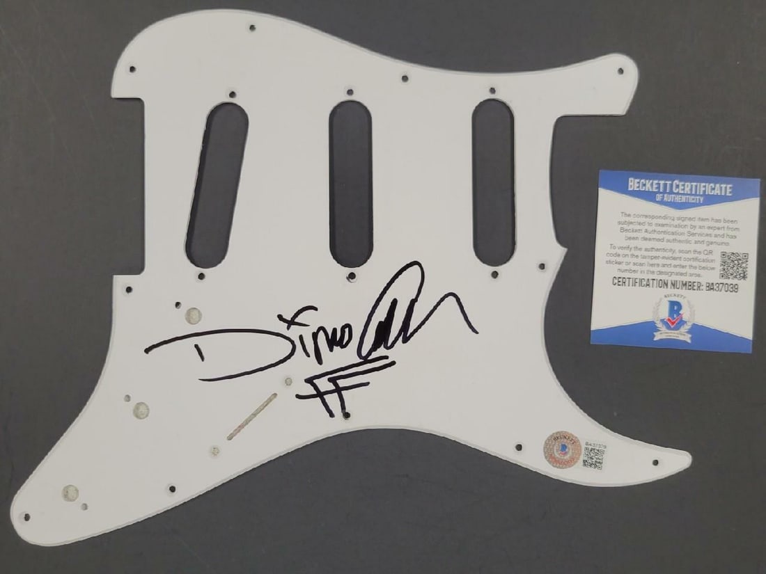 White Guitar Pickguard Autographed by Dino Cazares Fear Factory Beckett Authenticated: White Guitar Pickguard Autographed by Dino Cazares Fear Factory Beckett Authenticated This is an original white electric guitar pickguard signed by Dino Cazares of Fear Factory. The autograph has been