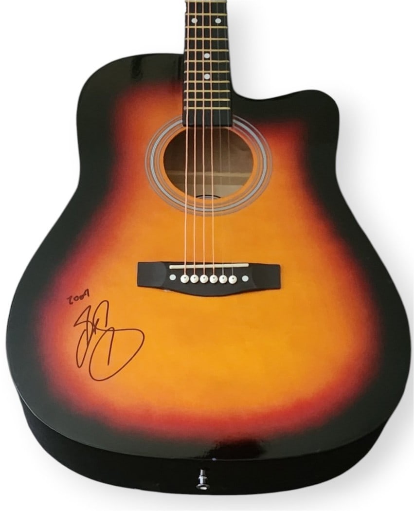 Acoustic Guitar Signed by Ruben Studdard JSA Authenticated: Acoustic Guitar Signed by Ruben Studdard JSA Authenticated This pre-owned acoustic guitar is signed by Ruben Studdard and includes a matching guitar pick. The autograph has been authenticated by James