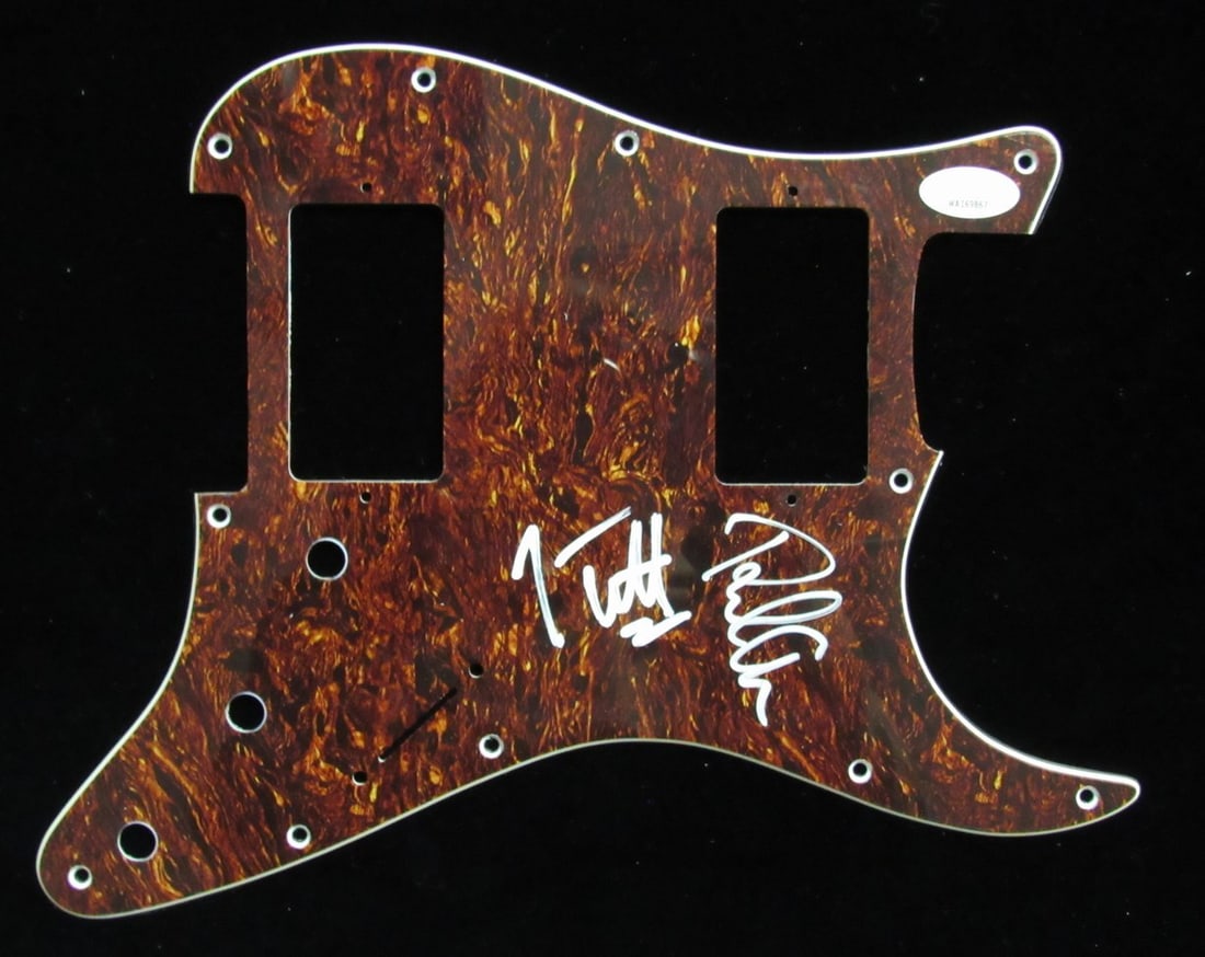 Guitar Pickguard Signed by Joe Elliott and Phil Collen with JSA Authentication: Guitar Pickguard Signed by Joe Elliott and Phil Collen with JSA Authentication This is an original guitar pick guard signed by Joe Elliott and Phil Collen of Def Leppard. The signatures are authentica