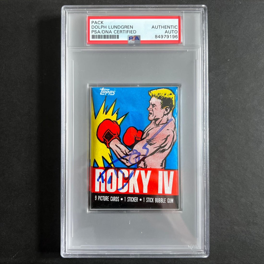 1985 Topps Rocky IV Dolph Lundgren Signed Pack PSA/DNA: 1985 Topps Rocky IV Dolph Lundgren Signed Pack PSA/DNA This listing features a 1985 Topps Rocky IV trading card pack signed by Dolph Lundgren, who famously portrayed Ivan Drago in the film. The autogr