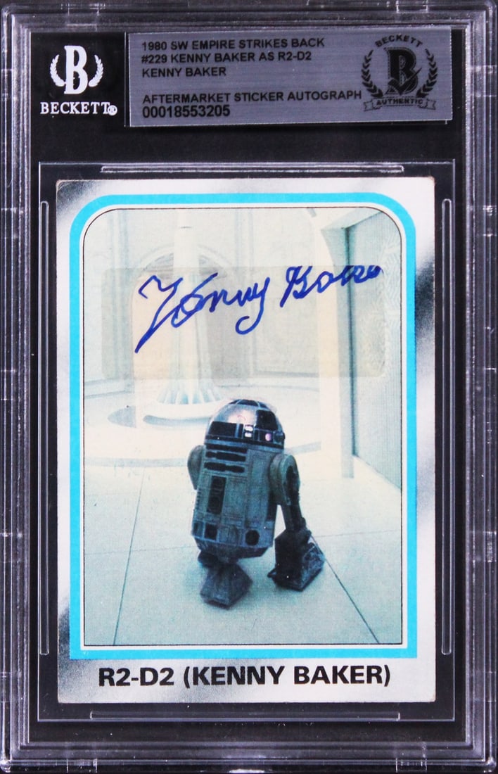 Kenny Baker Signed Star Wars Empire Strikes Back Card BAS Slabbed: Kenny Baker Signed Star Wars Empire Strikes Back Card BAS Slabbed This autographed card features the signature of Kenny Baker, known for his role in Star Wars, specifically from The Empire Strikes Bac