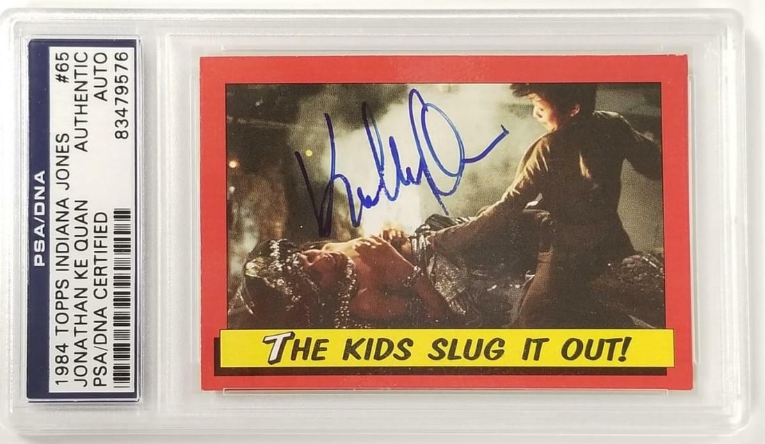 Jonathan Ke Quan Autographed 1984 Topps Indiana Jones #65 Card PSA Certified: Jonathan Ke Quan Autographed 1984 Topps Indiana Jones #65 Card PSA Certified This is a signed 1984 Topps Indiana Jones #65 card featuring Jonathan Ke Quan, known for his role in the film "Indiana Jone