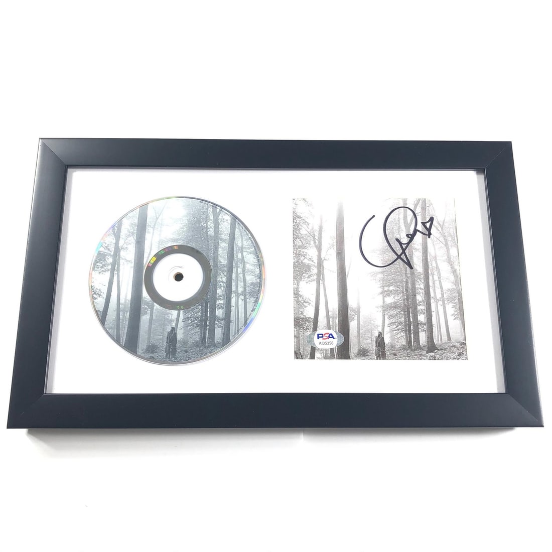 Taylor Swift Framed Signed Folklore CD Cover PSA/DNA Authentic: Taylor Swift Framed Signed Folklore CD Cover PSA/DNA Authentic This framed CD album cover features the signature of Taylor Swift and is an original piece from her acclaimed album, Folklore. The autogr