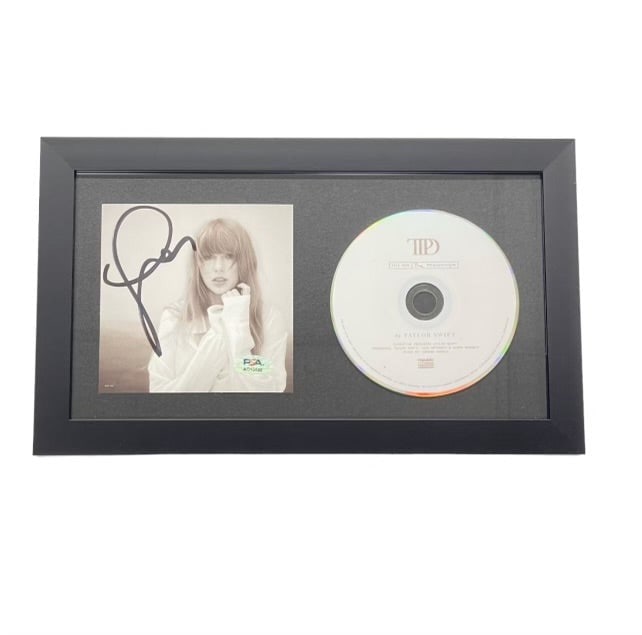 Framed Taylor Swift Signed CD Cover PSA/DNA The Tortured Poets Department: Framed Taylor Swift Signed CD Cover PSA/DNA The Tortured Poets Department This listing features a framed CD album cover of 'The Tortured Poets Department,' beautifully signed by the acclaimed artist T