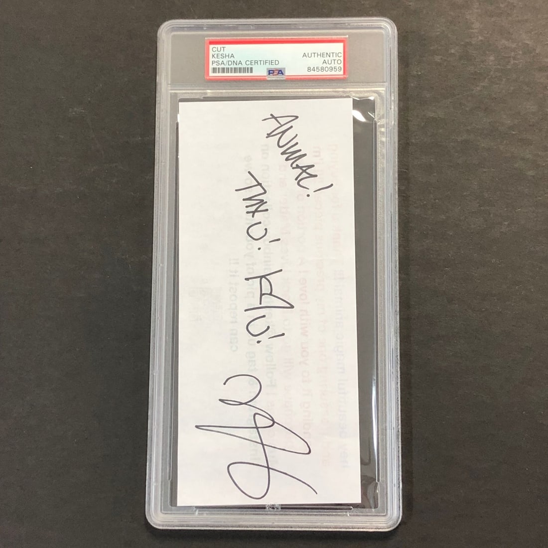 Kesha Autographed Cut PSA/DNA Certified Collectible: Kesha Autographed Cut PSA/DNA Certified Collectible This offering features a slabbed cut signed by Kesha, showcasing her authentic autograph. The signature has been verified by PSA/DNA, ensuring its l