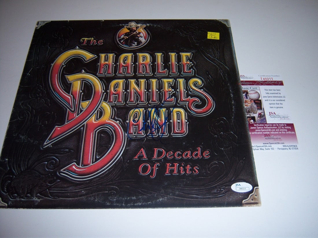 Charlie Daniels Signed Decade of Hits Album Cover JSA COA Authenticated: Charlie Daniels Signed Decade of Hits Album Cover JSA COA Authenticated This is an original "A Decade of Hits" LP record album cover signed by Charlie Daniels. The album originates from the United Sta