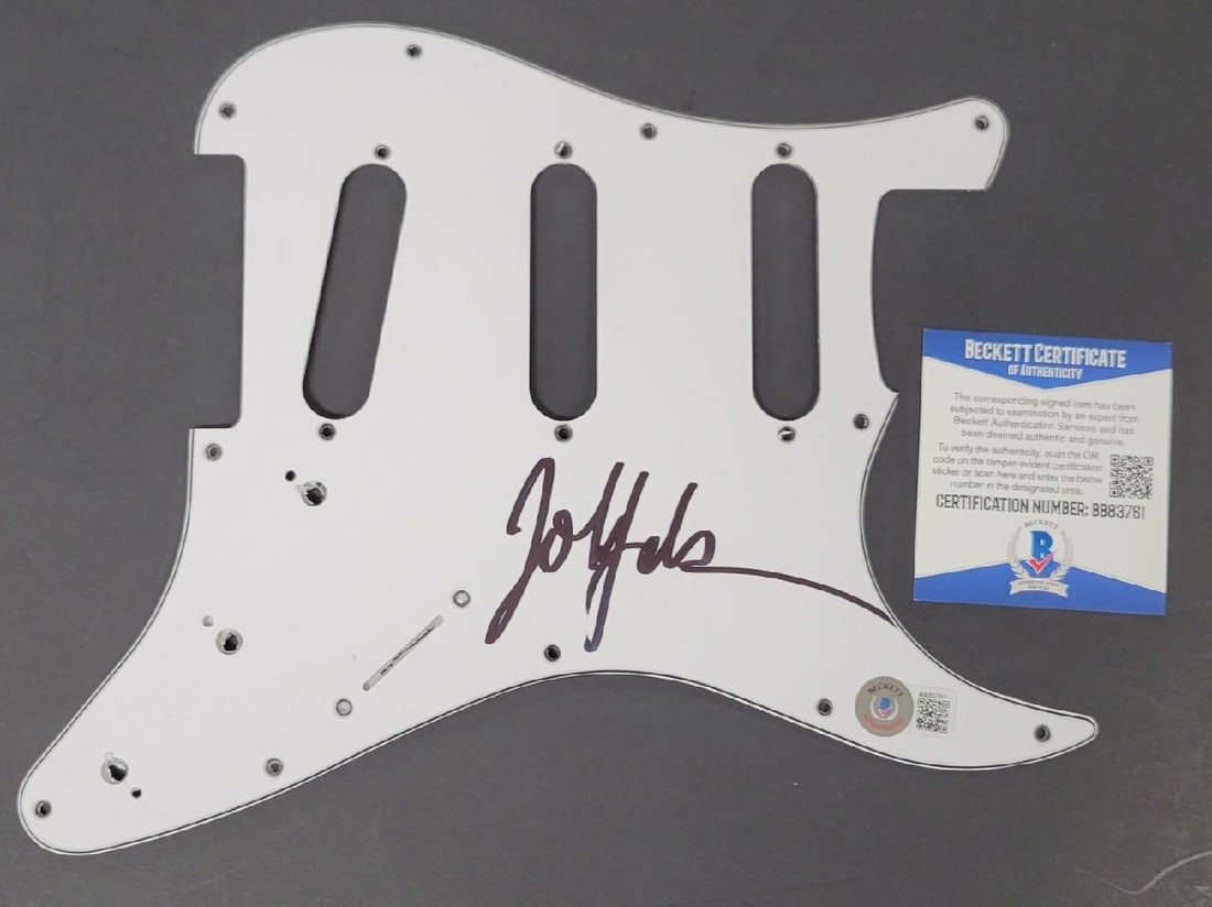 Autographed Guitar Pickguard by John Feldmann with Beckett COA: Autographed Guitar Pickguard by John Feldmann with Beckett COA This is an original guitar pickguard signed by John Feldmann of Goldfinger. The autograph is authenticated by Beckett and includes a cert