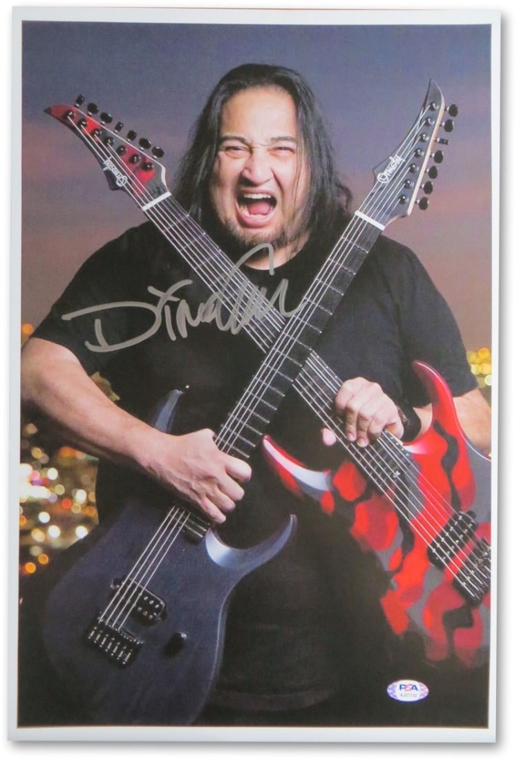 Dino Cazares Signed 12x18 Photo with Two Guitars PSA Authenticated: Dino Cazares Signed 12x18 Photo with Two Guitars PSA Authenticated This is a stunning 12X18 photograph of Dino Cazares, the renowned guitarist from Fear Factory, personally signed by him. The autograp
